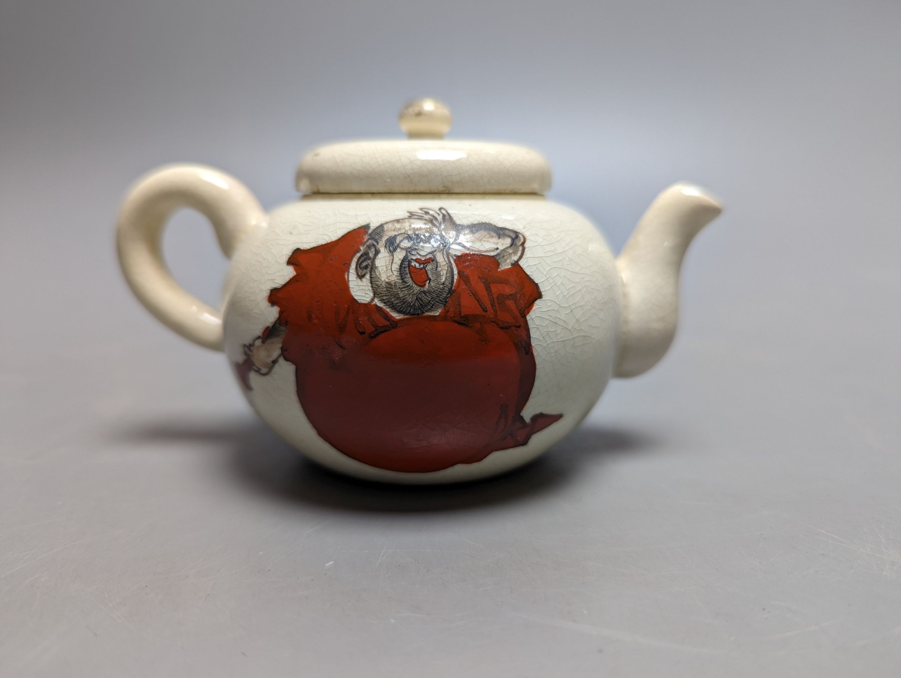 A Japanese pottery 'Daruma' teapot and pouring jug, circa 1900
